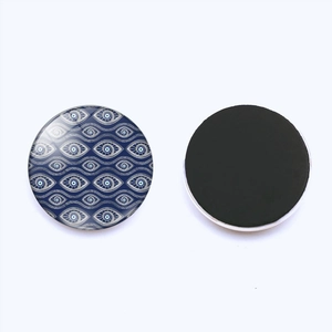 Detailed view of evil eye glass fridge magnet with circular magnetic backing