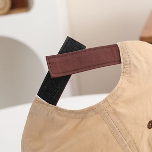 Detail of adjustable hook and loop strap on quick-dry khaki kids baseball cap