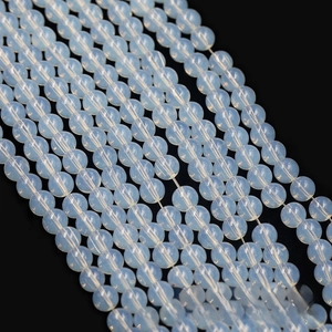Macro view of polished white translucent opal glass beads for DIY jewelry making