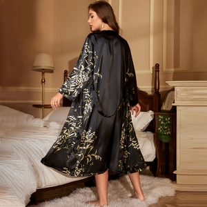 Elegant black floral satin robe and kimono nightgown set shown in a cozy bedroom scene