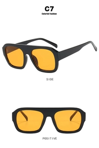 Detail view of model C7 square sunglasses with thick black frame and bright orange lenses