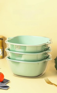 Three-piece stackable double-layer drain basket set with green inner and clear outer bowl