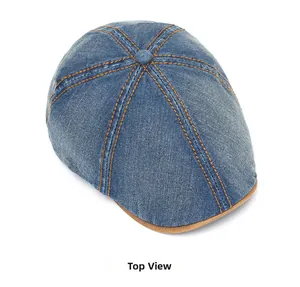 Top view of retro washed denim flat cap with orange contrast stitching and brown brim trim