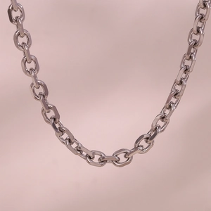Close-up of thick silver link chain necklace showing polished metal texture and craftsmanship