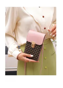 Detail of pink leather flap and vintage floral print on mini crossbody bag with gold lock