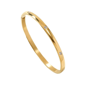 Elegant gold titanium steel bangle with three embedded crystals on a polished surface