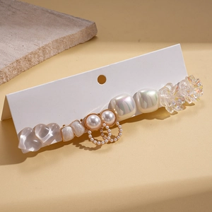 Detail of 10-piece earring set featuring resin pearls, heart and floral designs on card