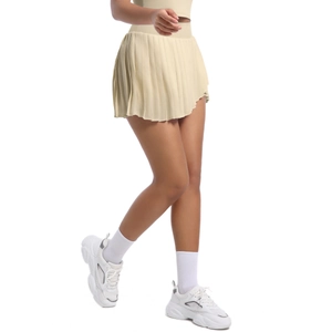Detail of cream pleated tennis skirt fabric texture and high-waisted design features