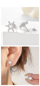 Detail view of silver snowflake earrings with cubic zirconia and screw-back closure