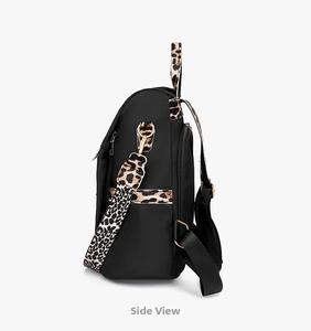 Detail view of fashion backpack with leopard print straps and gold hardware zippers