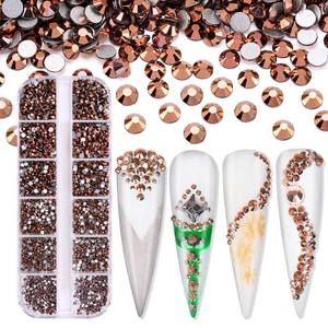 Detail of brown nail art rhinestones in 12-slot storage box with decorated false nails