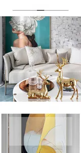 Detail of luxury electroplated golden elk statues in standing and kneeling poses