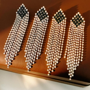 Detail view of vintage geometric tassel earrings with zircon fringe on premium leather case