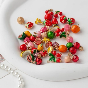 Colorful 18K gold plated fruit charms set for DIY jewelry making on white ceramic tray