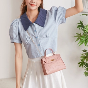 Pink mini crossbody bag with cartoon embossed patterns and gold chain strap