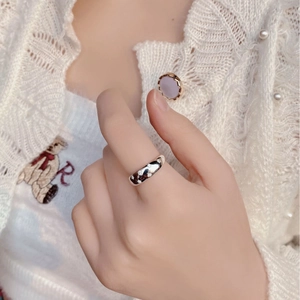 Close-up of S925 silver ring with star-shaped zircon inlays on model finger
