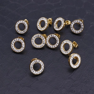 Minimalist gold hollow round earrings with sparkling crystals on black leather backdrop