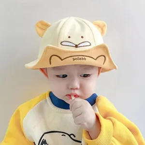 Close-up of baby cotton bucket hat with 3D ears and cartoon embroidery in yellow and beige