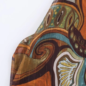 Macro detail of bohemian print fabric with vertical gold metallic threads on top