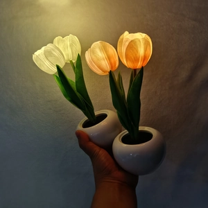 Detailed view of LED tulip night light showing soft glowing petals and ceramic pot