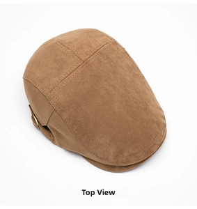 Top view of brown suede flat cap showing four-panel stitching and metallic buckle detail