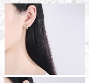 Close-up of minimalist gold-plated hoop earrings with micro-paved cubic zirconia accents
