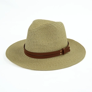 Detail of straw Panama hat with brown leather band and golden rivet accents