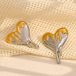 Lava style heart stud earrings in gold and silver dual-tone plating on knit background