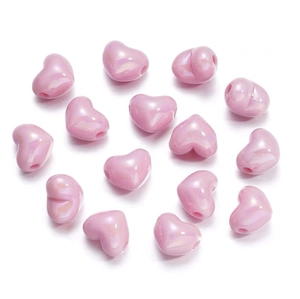 Macro shot of 15 pink heart-shaped DIY beads with a pearlescent finish for jewelry making