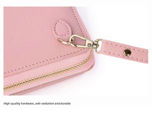 Detail of pink faux leather phone bag showing high-quality gold metal zipper and wrist strap
