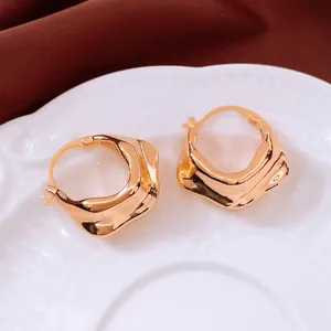 Minimalist 18K gold plated irregular pleated hoop earrings displayed on white porcelain