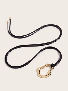 Macro shot of minimalist gold metal pendant and black knotted leather cord detail
