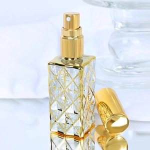 Macro detail of a 12ml glass perfume bottle with gold electroplated diamond pattern