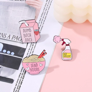 Detailed view of fun pink enamel pins set with Strawberry Milk and Ramen bowl designs