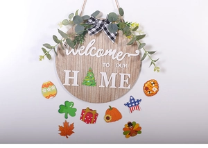 Detail of wooden welcome sign with interchangeable magnetic seasonal holiday icons