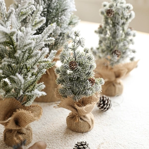 Mini flocked snowy Christmas trees with pine cones and burlap base for desk decor