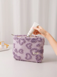 Cute purple plush makeup bag with heart pattern and zipper for cosmetic storage
