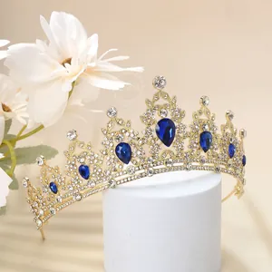 Close-up of golden luxury crown with blue teardrop stones and white crystals