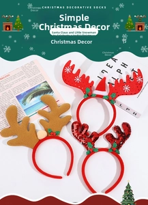 Detail view of festive Christmas headbands with reindeer antlers, sequins and berries