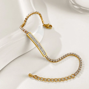 Detail of gold-plated tennis bracelet with rectangular white zircon and adjustable lobster clasp