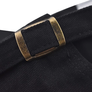 Detailed close-up of a black cotton baseball cap's adjustable antique brass metal buckle