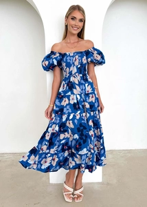 Detail of blue floral off-shoulder dress featuring puff sleeves and tiered cake skirt