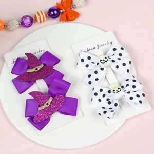 Detail of Halloween hair clips with ghost and wizard hat bows on cardboard packaging
