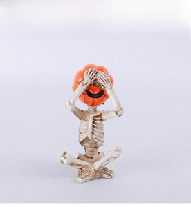 Detailed view of Halloween pumpkin head skeleton figurine in meditation pose
