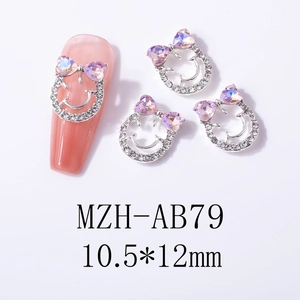 Detail of pink crystal heart bow and smiley face nail charm, dimensions 10.5x12mm