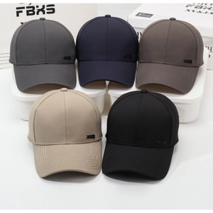 Detail view of five baseball caps in varied colors featuring a metal logo and topstitching