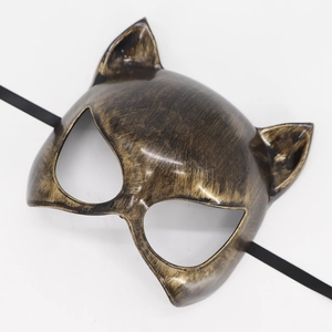 Detailed view of bronze catwoman mask with distressed finish and elastic strap
