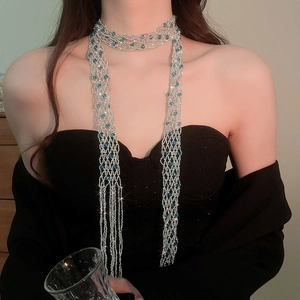 Elegant detail view of a sparkling crystal beaded fringe scarf necklace on a model
