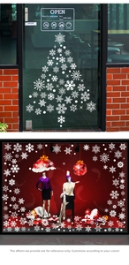 Detailed view of white snowflake stickers and Christmas tree decals on glass windows