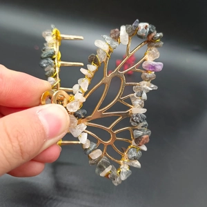 Detail of handmade butterfly hair claw with natural amethyst and colorful crystal gravel